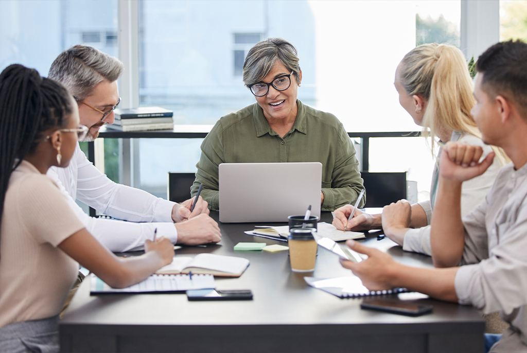a group of people around a table and talking